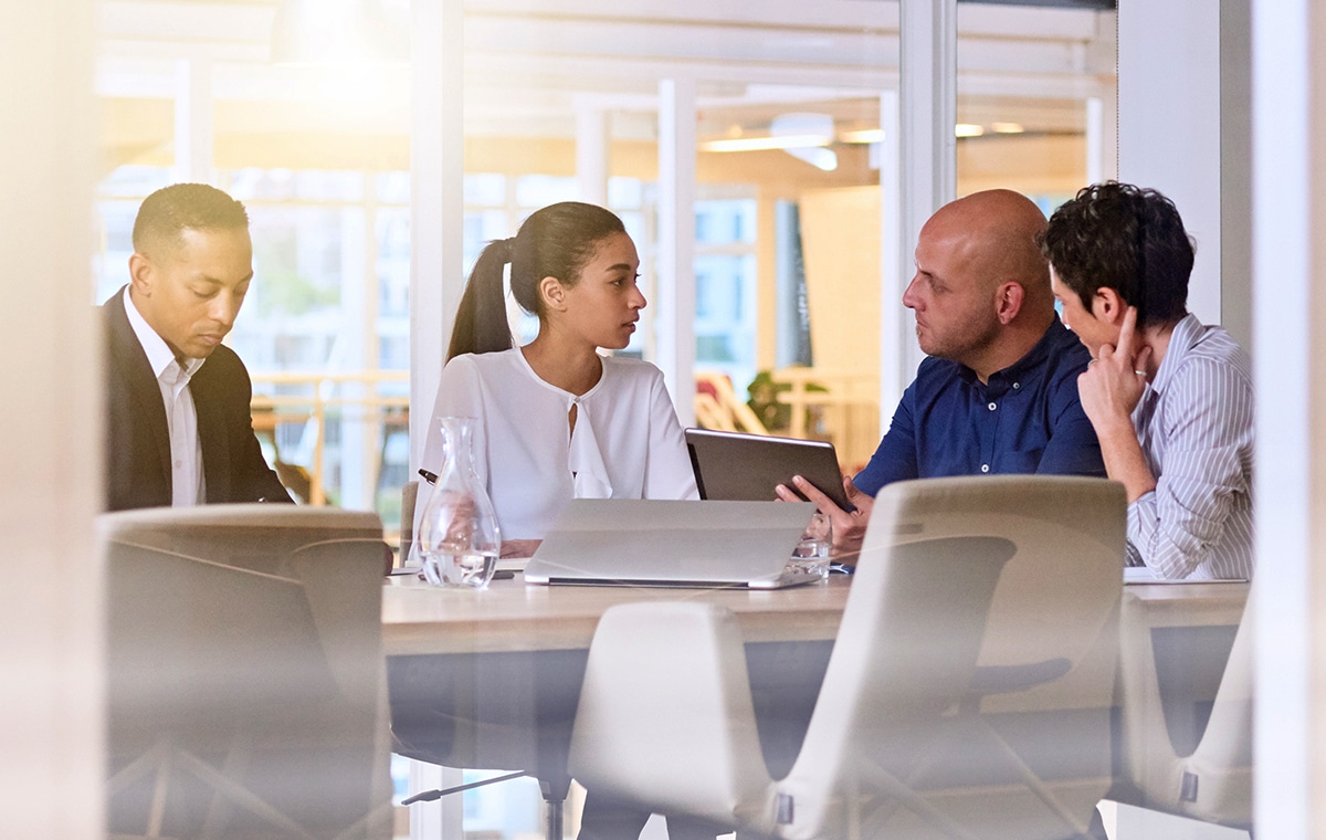 group,of,happy,coworkers,discussing,in,conference,room