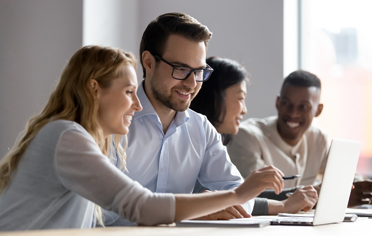 group,of,happy,coworkers,discussing,in,conference,room