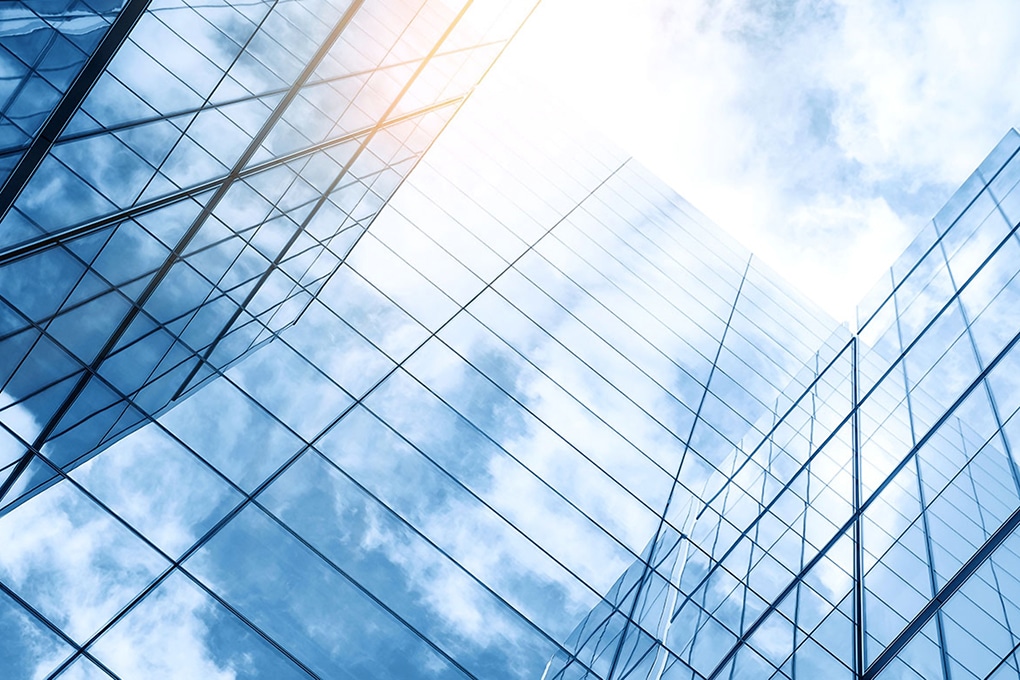 glass,buildings,with,cloudy,blue,sky,background