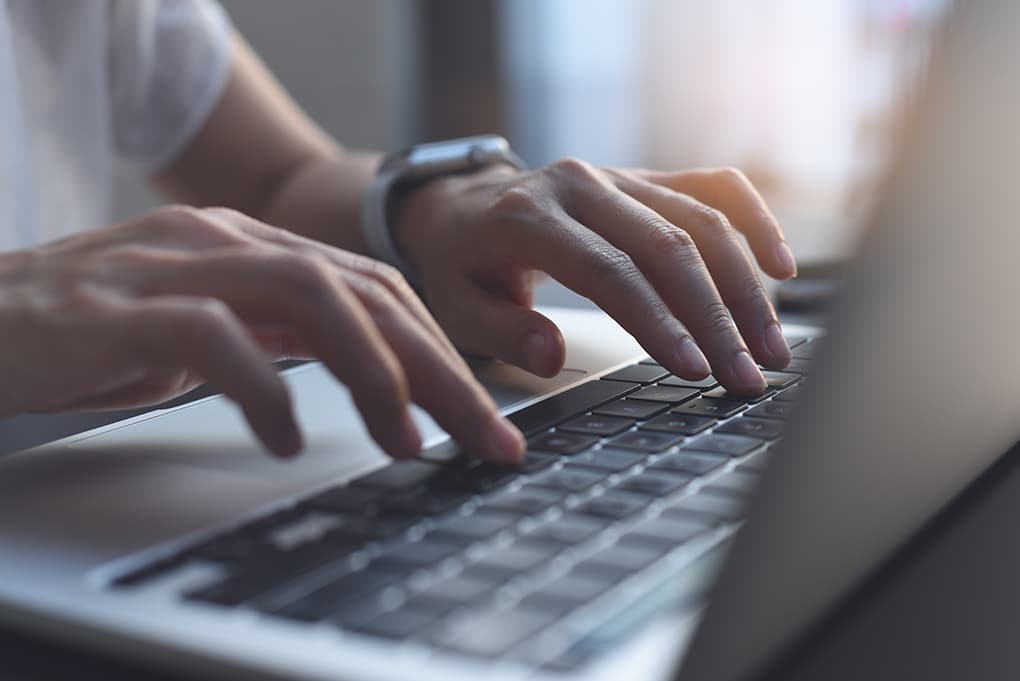 close,up,image,of,woman,hands,typing,on,laptop,computer