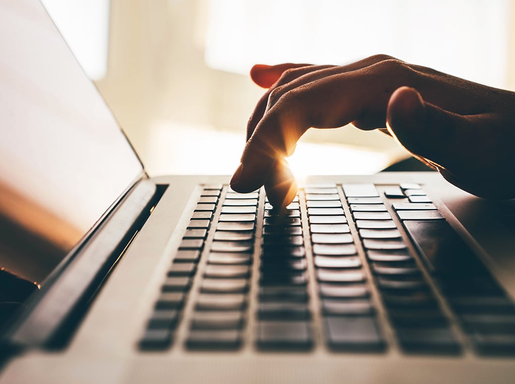 woman,working,at,home,office.close,up,hand,on,laptop,keyboard.