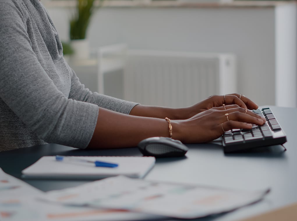 close up,of,teenager,with,dark,skin,hands,on,keyboard,typing