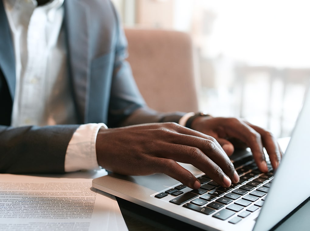 businessman,working,on,laptop,with,some,documents,on,table.,close