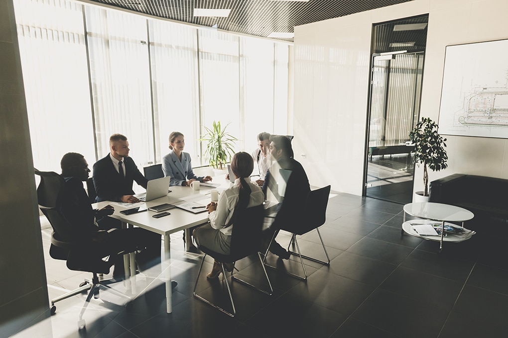 silhouettes,of,people,sitting,at,the,table.,a,team,of