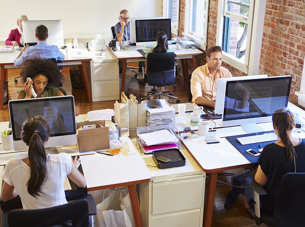 wide,angle,view,of,busy,design,office,with,workers,at